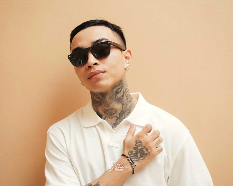 A man wearing wooden sunglasses